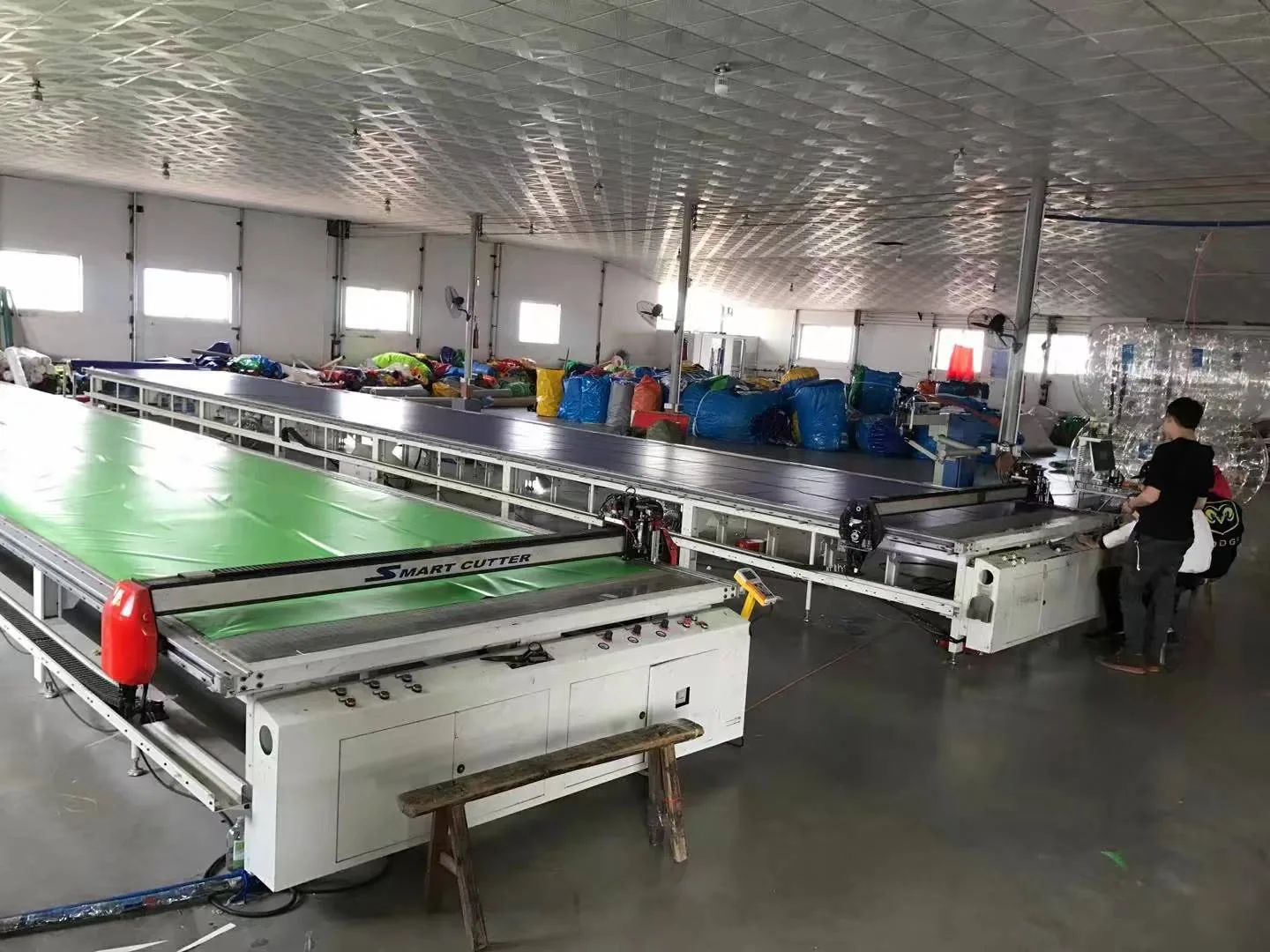 Commercial inflatable production and material preparation for site-ready attraction construction