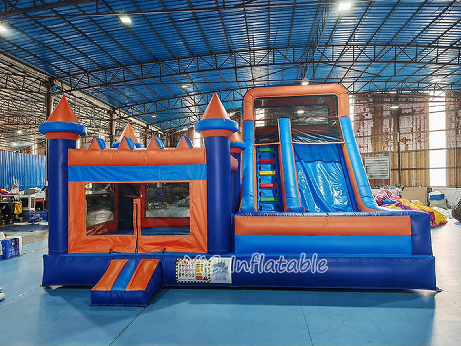 rainbow themed inflatable bounce-and-slide attraction front view
